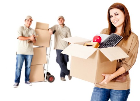 Office desks, filing cabinets, and stock being loaded for transport