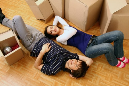 Professional movers loading furniture for a fast Hithergreen relocation